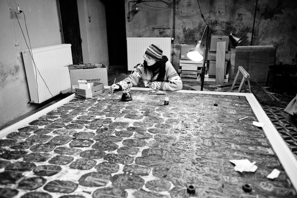 Marie Morel au travail dans un de ses ateliers du Petit-Abergement. Elle est en train de peindre un tableau.