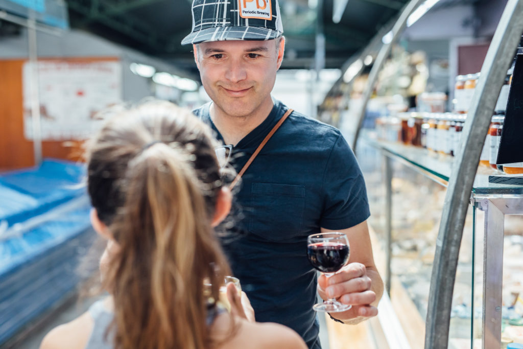 Get to know the Parisian neighborhood of Le Marais on a food walking tour with a guide who introduces you to local food vendors and artisans.
A tourist is tasting wine in the Marché des enfants rouges, Paris, on July 23th, 2019.