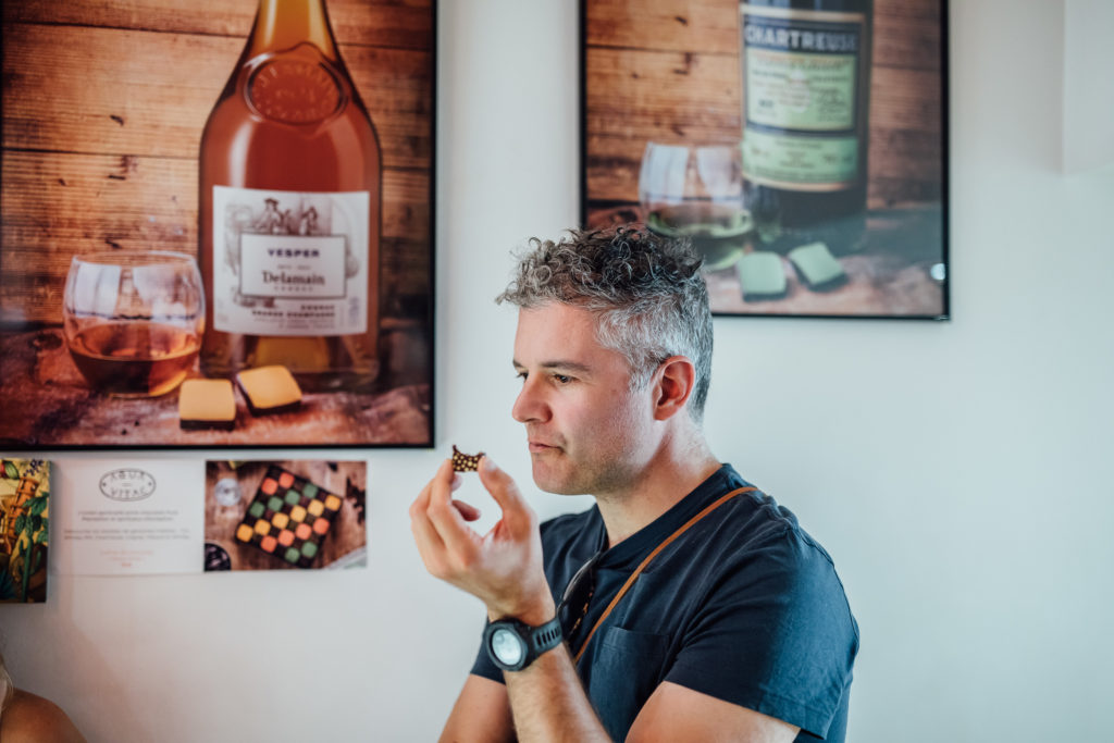 Get to know the Parisian neighborhood of Le Marais on a food walking tour with a guide who introduces you to local food vendors and artisans.
A tourist is tasting a piece of chocolate, from Edwart shop, chocolatier, Paris, on July 23th, 2019.