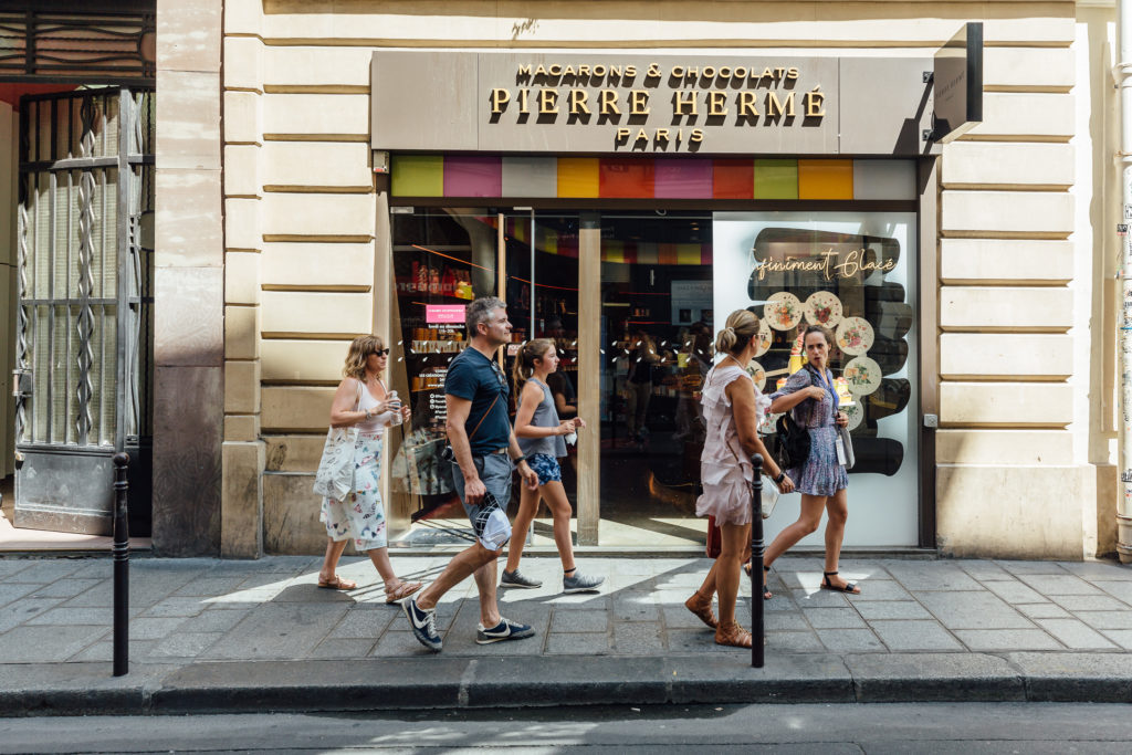 Get to know the Parisian neighborhood of Le Marais on a food walking tour with a guide who introduces you to local food vendors and artisans.
Tourists are leaving Pierre Hermé shop, chocolats et macarons, Paris, on July 23th, 2019.