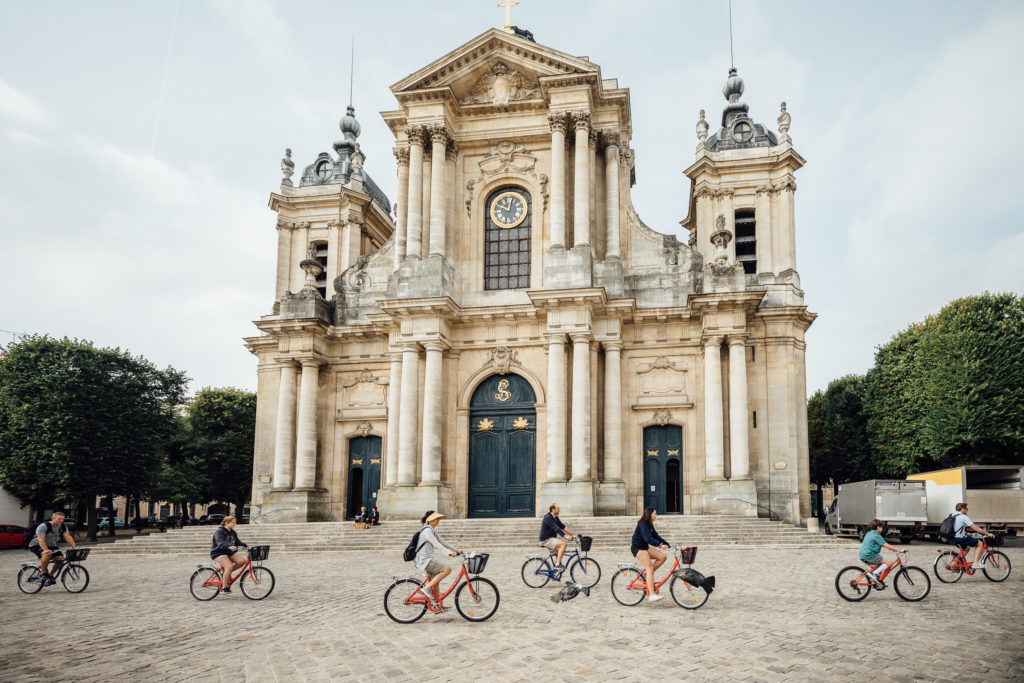 The gardens of Versailles span an impressive 1,976 acres. Rather than exploring the sprawling grounds on foot, pedal your way around with an informative guide on this full-day Versailles bike tour from Paris. 
People are starting the tour in Versailles downtown and passing by different landmarks. Versailles, on August 3rd, 2019.